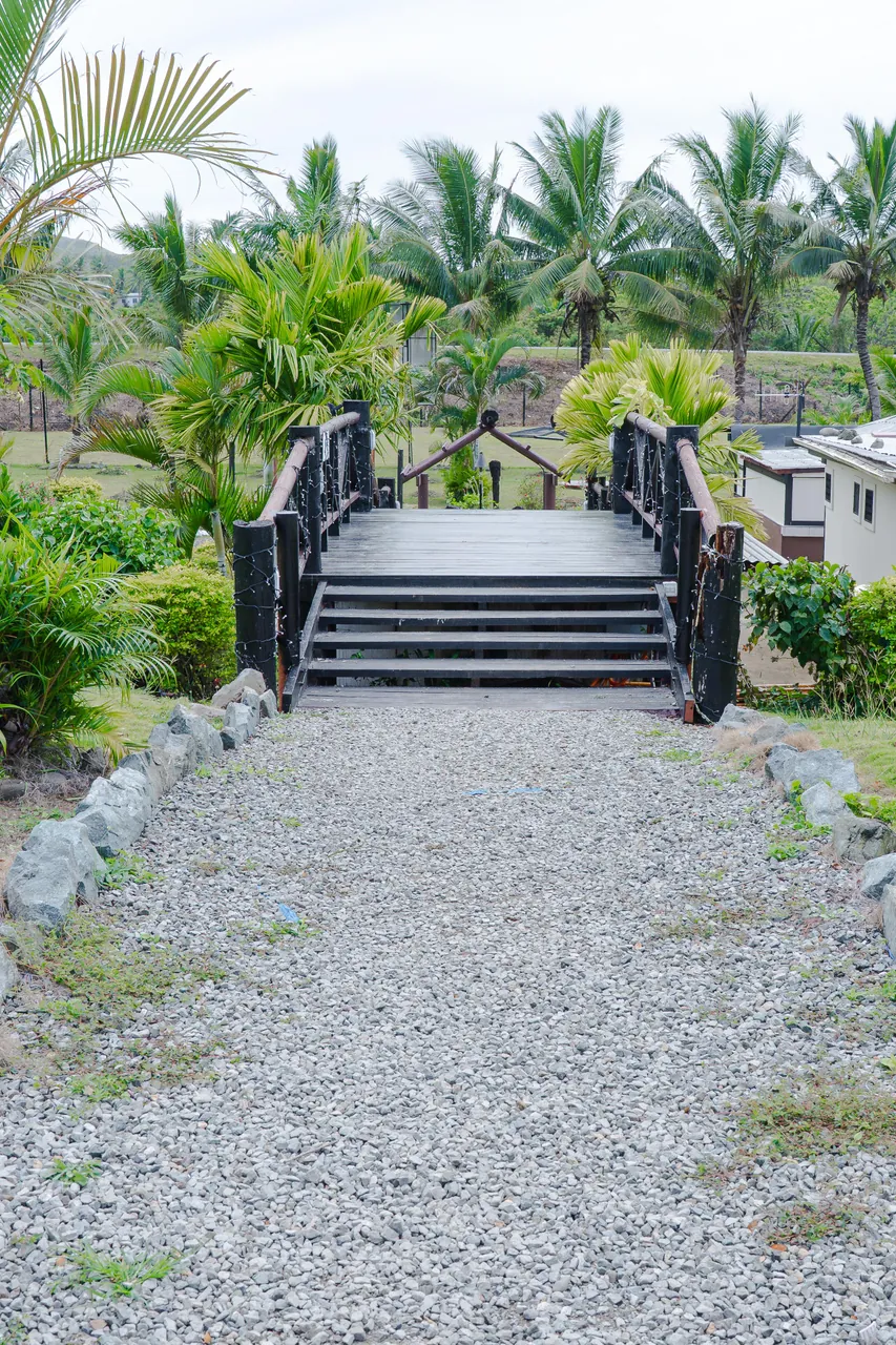 A small footbridge along a path through the gardens