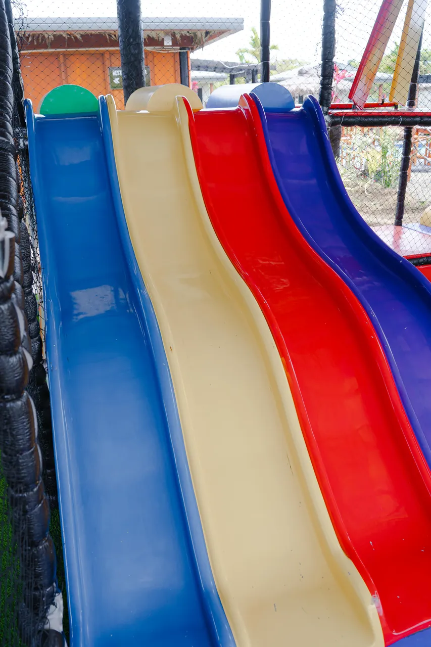Four colourful slides side by side at Kids Playland