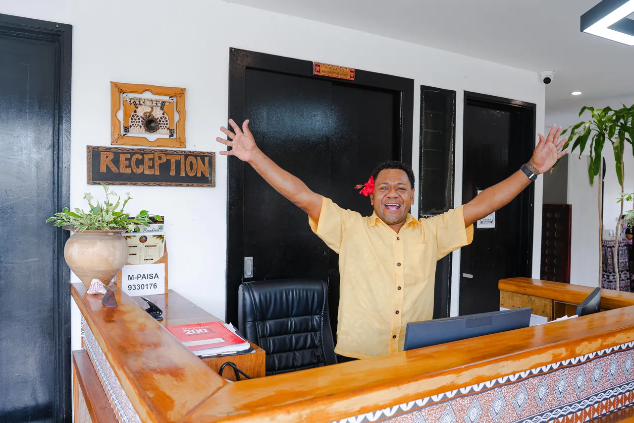 A member of the BulaBard team welcoming guests at reception