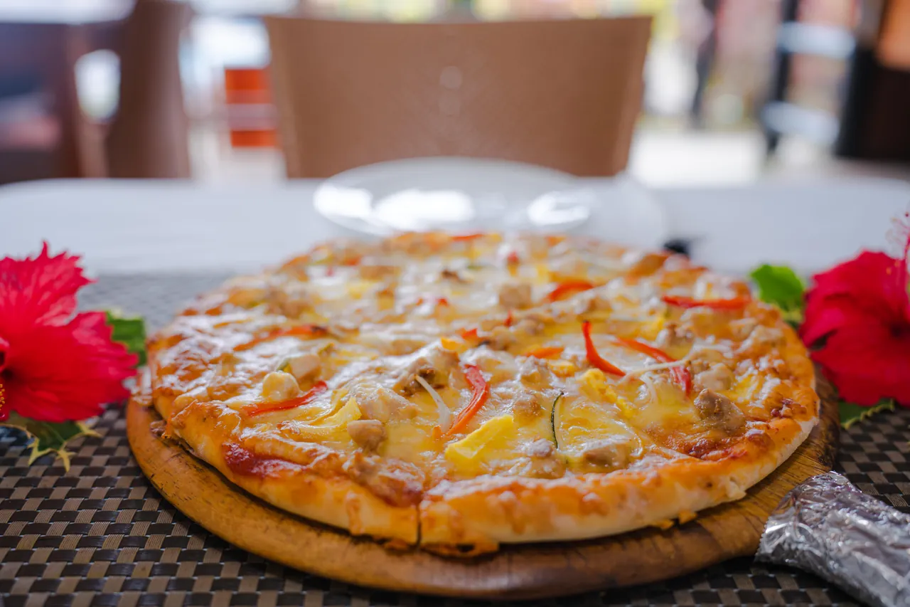 A freshly prepared pizza served on a wooden board