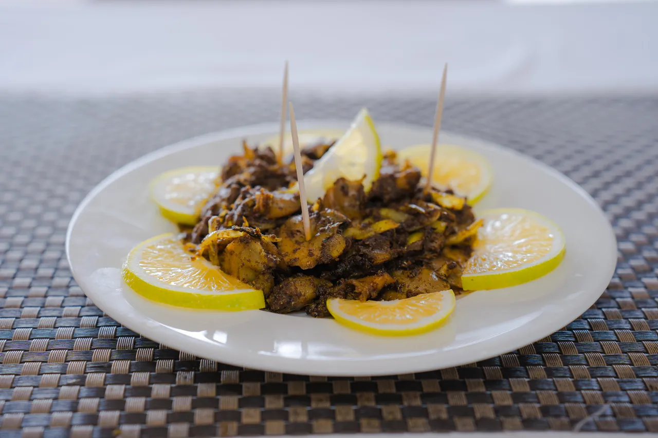 A savoury restaurant dish served with lemon slices