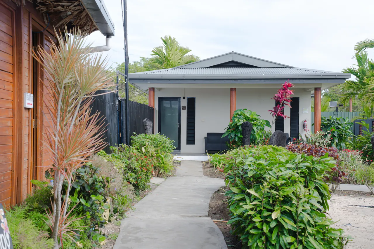 A garden path leading to a villa among tropical planting